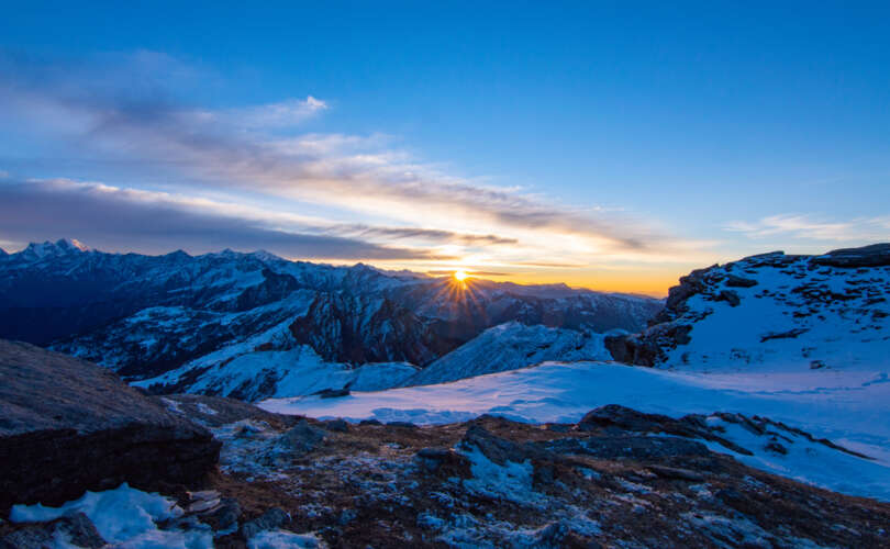 "Kedarkantha trek summit view with snow-covered Himalayan peaks at sunrise, Uttarakhand India"